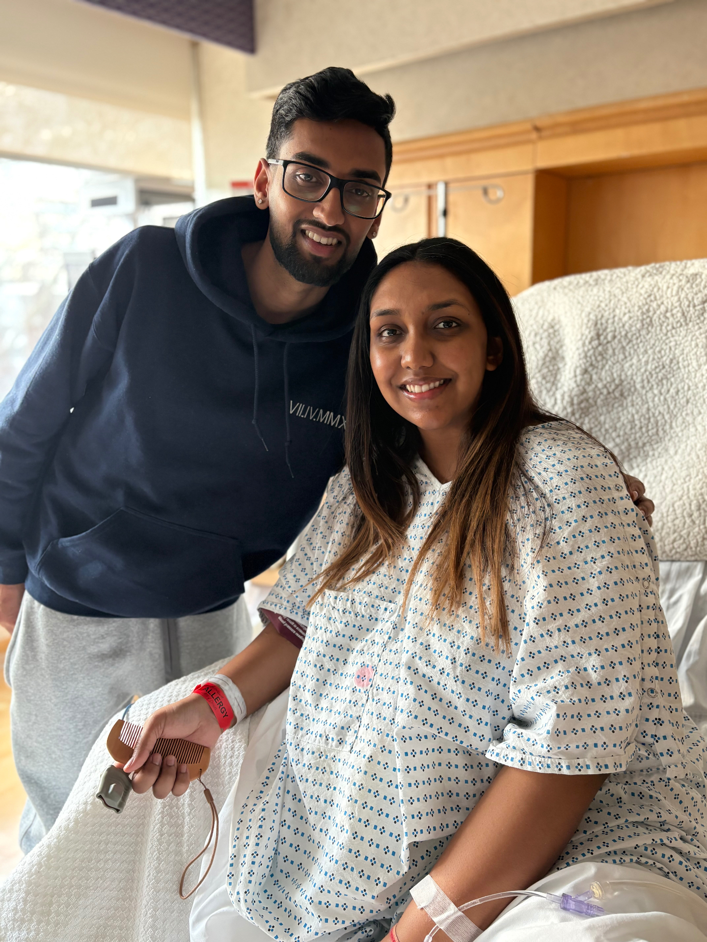 Expectant parents smiling together in a hospital birthing suite